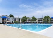 Thumbnail 3 of 51 - a swimming pool with umbrellas and buildings in the background at Copper and Quarry Village, Pikesville