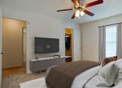 Thumbnail 19 of 31 - Bedroom with bed, ceiling fan and light at Crosswinds Apartments, Pearl, MS