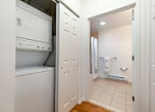 Thumbnail 33 of 46 - a laundry room with a washer and dryer and a door to a bathroom at Pier Village Apartments, Long Branch, 07740