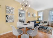 Thumbnail 24 of 46 - a living room with a couch and a table with chairs at Pier Village Apartments, Long Branch, New Jersey