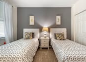 Thumbnail 30 of 46 - two twin beds in a bedroom with grey walls and a window at Pier Village Apartments, Long Branch, 07740