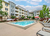 Thumbnail 11 of 46 - our apartments have a pool and lounge chairs in front of our building at Pier Village Apartments, Long Branch, 07740
