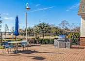 Thumbnail 17 of 18 - A patio with a table, chairs, and an umbrella. at Greenbrier Estates, Slidell, 70460