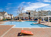 Thumbnail 2 of 18 - A pool surrounded by a brick patio with a bench in the foreground. at Greenbrier Estates, Slidell, 70460
