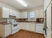 Thumbnail 9 of 32 - Kitchen with white cabinets at Lakeshore Landing Apartments, Mississippi