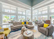 Thumbnail 11 of 47 - Living room with couch and table at Lumen Apartments, Hampton, VA