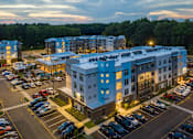 Thumbnail 40 of 47 - Exterior area at night at Lumen Apartments, Hampton, 23666