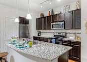 Thumbnail 12 of 33 - Modern kitchen with stainless steel appliances and granite counter tops at Mansfield on the Green, Milwaukie, 76063