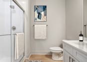 Thumbnail 6 of 29 - A bathroom with a toilet, sink, and shower. at Midtown Row, Alabama
