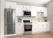 Thumbnail 4 of 29 - A kitchen with white cabinets and a stainless steel refrigerator. at Midtown Row, Montgomery, 36106