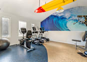 Thumbnail 9 of 31 - a gym with exercise machines and a surfboard on the wall at Quail Ridge, Plainsboro Township, 08536