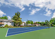 Thumbnail 11 of 31 - a tennis court with trees and a house in the background at Quail Ridge, Plainsboro Township, NJ