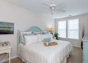 Thumbnail 21 of 29 - Bedroom with cozy bed at River House Apartments, Norfolk, Virginia