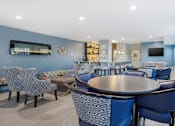 Thumbnail 13 of 26 - A modern dining room with a large table surrounded by chairs.