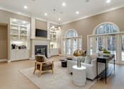 Thumbnail 5 of 21 - A modern living room with a fireplace and a television.