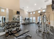 Thumbnail 6 of 21 - A spacious home gym with a variety of exercise equipment.