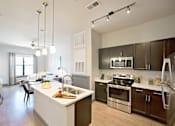 Thumbnail 9 of 13 - a kitchen with a large island and stainless steel appliances at The Addison, Baton Rouge, 70836