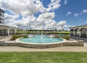 Thumbnail 5 of 20 - a fountain in the middle of a pool in front of a building