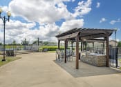 Thumbnail 9 of 20 - an outdoor patio with tables and chairs and a pergola