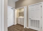 Thumbnail 20 of 20 - a laundry room with a washer and dryer and a closet with a door