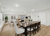 Thumbnail 5 of 31 - A dining room with a table surrounded by chairs.