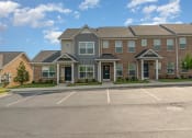 Thumbnail 10 of 36 - a large brick building with a parking lot in front of it