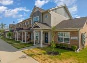 Thumbnail 8 of 36 - a row of houses with a sidewalk in front of them