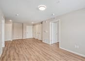Thumbnail 4 of 30 - A room with wooden floors and white walls.