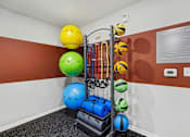 Thumbnail 4 of 31 - A fitness center with a variety of equipment and balls.