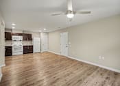 Thumbnail 5 of 43 - A kitchen with white appliances and wooden floors.
