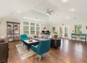 Thumbnail 11 of 36 - a living room with a vaulted ceiling and hardwood floors