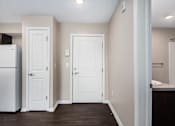 Thumbnail 14 of 40 - a renovated kitchen with white doors and a refrigerator