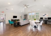 Thumbnail 17 of 36 - a living room with hardwood floors and a vaulted ceiling