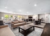 Thumbnail 15 of 40 - a living room with couches and chairs and a table