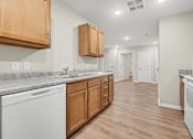 Thumbnail 6 of 31 - A kitchen with wooden cabinets and a marble countertop.