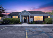 Thumbnail 7 of 49 - A building with a parking lot in front of it.