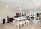 Thumbnail 11 of 42 - A kitchen with a white table and chairs.