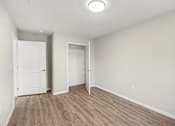 Thumbnail 16 of 31 - A room with a white door and a white wall.