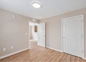 Thumbnail 9 of 30 - A room with a white door and a light on the ceiling.