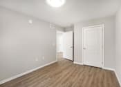 Thumbnail 17 of 31 - A room with a white door and a white wall.