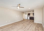 Thumbnail 14 of 42 - A room with a ceiling fan and wooden flooring.