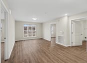 Thumbnail 18 of 31 - A room with wooden floors and white walls.
