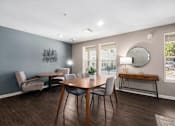 Thumbnail 27 of 40 - a dining room with a table and chairs and a mirror