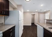Thumbnail 28 of 40 - a renovated kitchen with white appliances and wooden floors