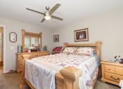 Thumbnail 27 of 36 - a bedroom with a bed and a ceiling fan