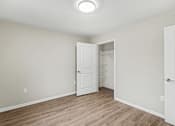 Thumbnail 15 of 31 - A room with a white door and a light on the ceiling.