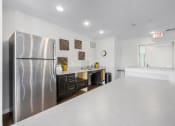Thumbnail 23 of 34 - a kitchen with a counter top and a refrigerator