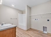 Thumbnail 26 of 30 - A bathroom with a sink, toilet, and a white door.
