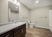 Thumbnail 22 of 43 - A bathroom with a sink, toilet, and a tub.
