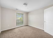 Thumbnail 24 of 34 - an empty room with carpet and a window